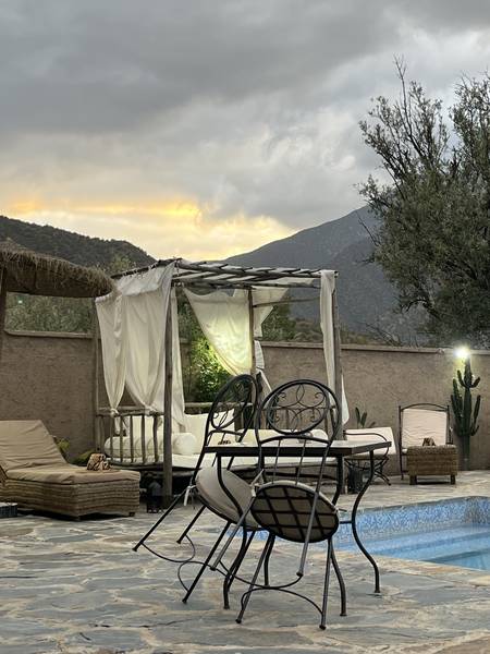 Soirée autour du brasero au bord de la piscine — Wild Valley Ouirgane, vue sur les montagnes du Haut Atlas